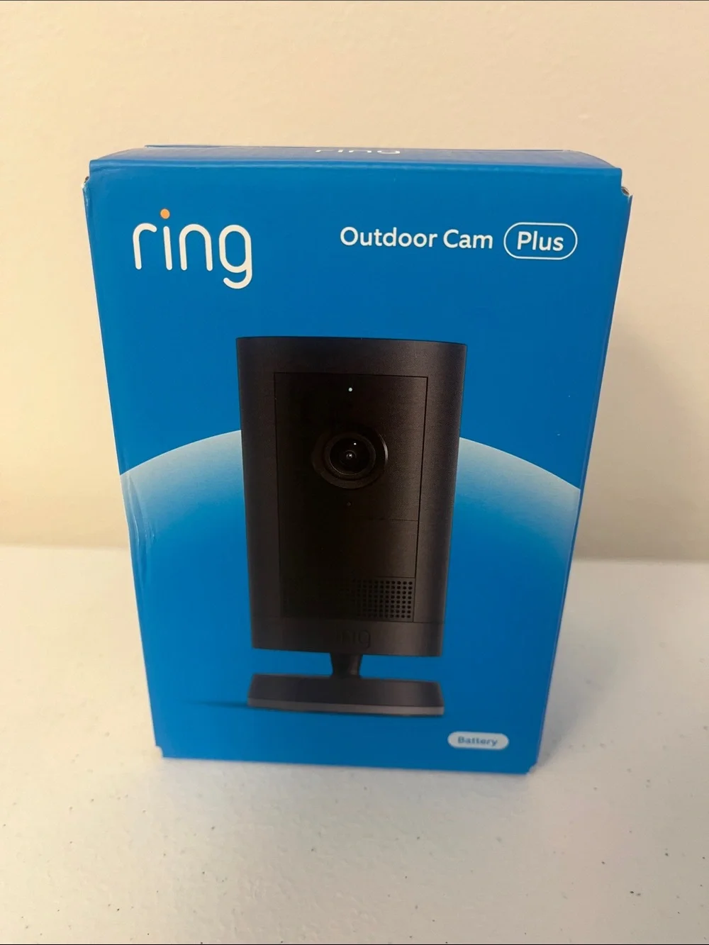Ring Outdoor Cam Plus in black and blue packaging